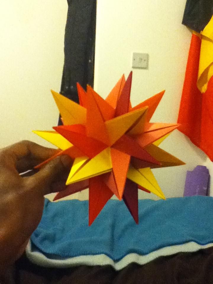 An orange and yellow spiked modular origami star